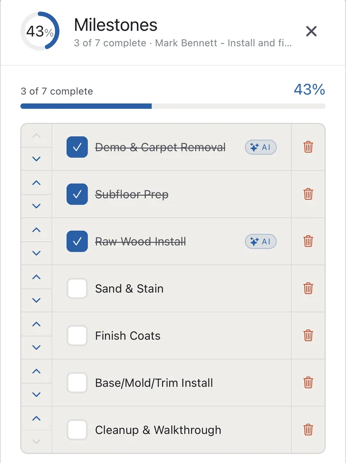The Supervisr milestones list for a remodel, showing demo, subfloor prep and raw wood install crossed off, with sanding, finish coats, trim and the final walkthrough still outstanding.